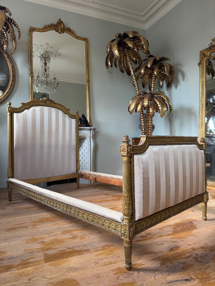 Pair of late 19th-century gilded wooden beds in Louis XVI style.