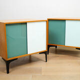 A pair of vintage mid-century bedside tables with glass sliding doors