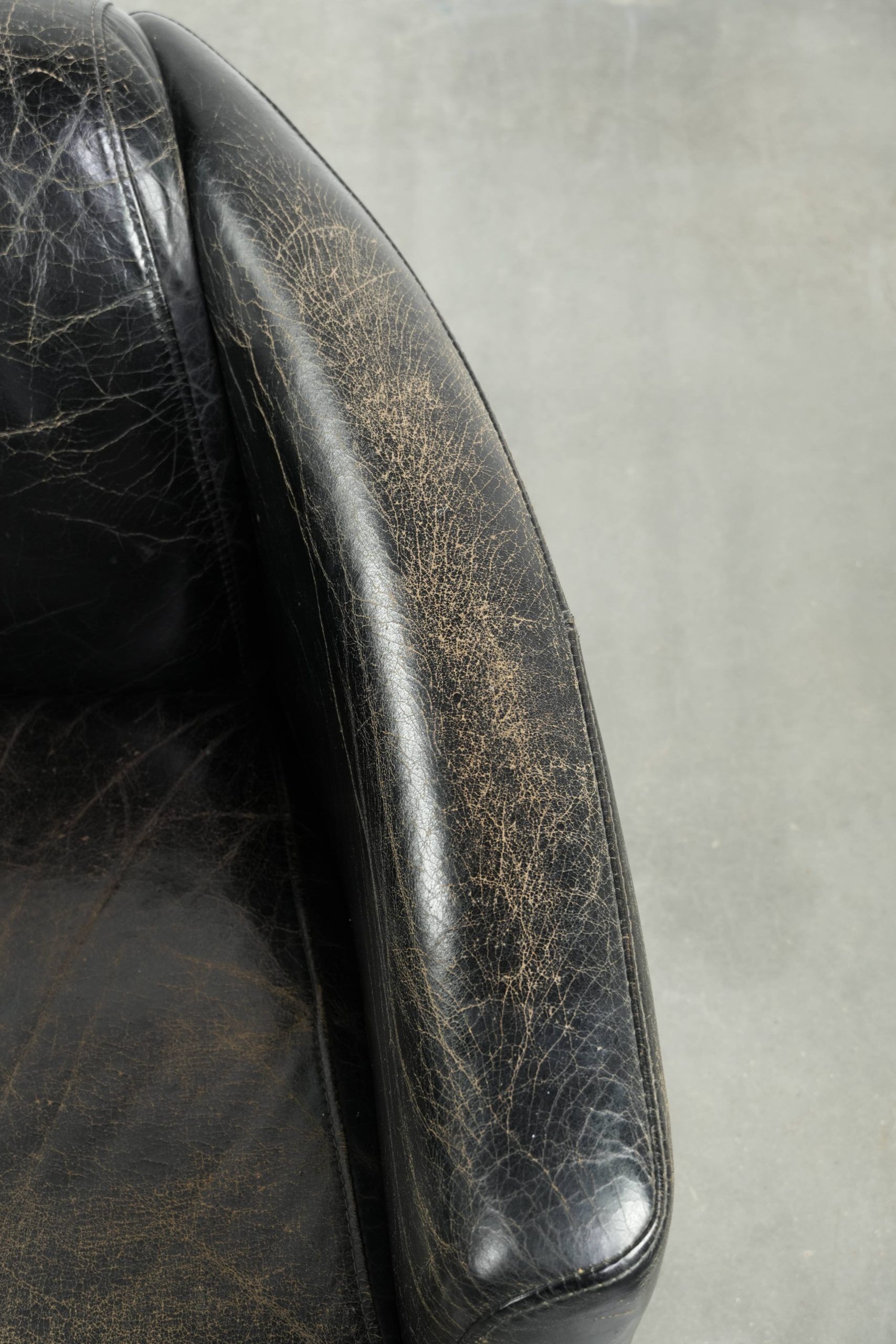 Black vintage cowhide aviator design armchair with characterful appearance