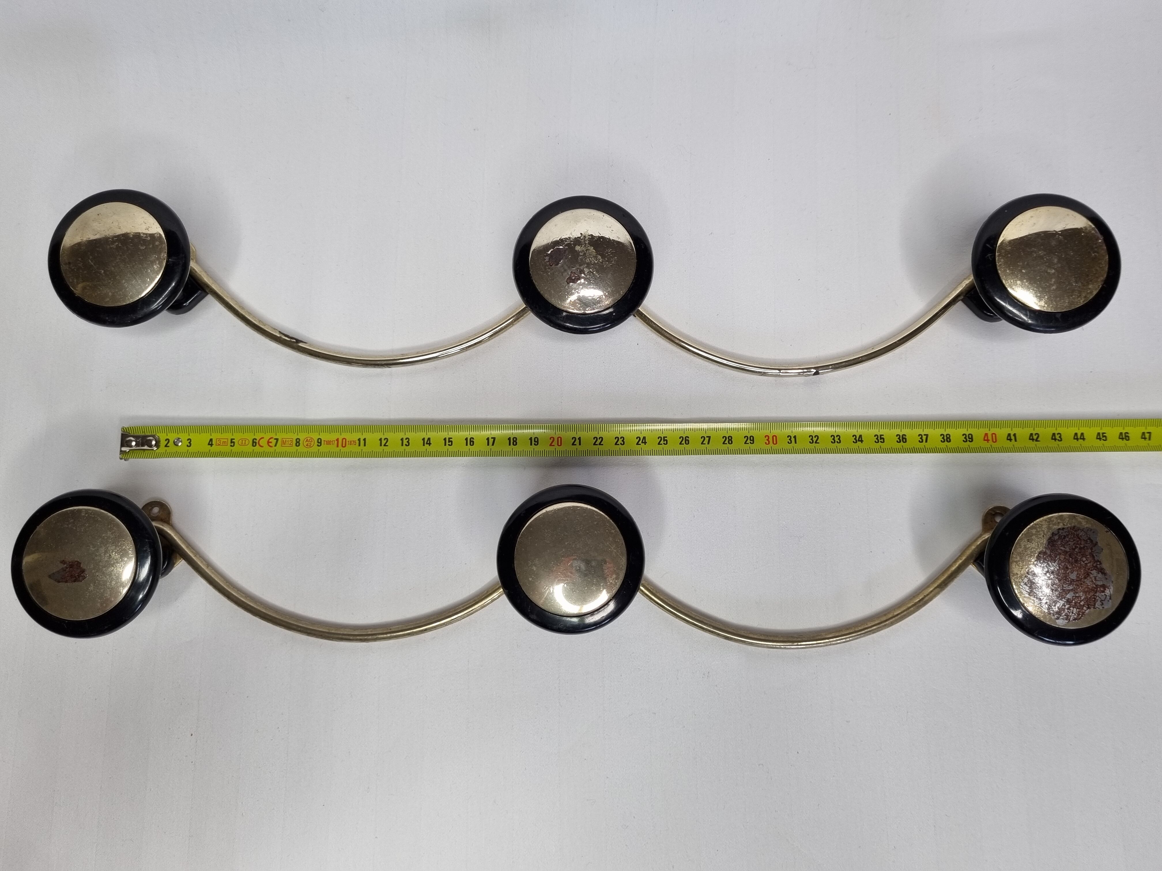 Pair of vintage wall coat racks in gold metal