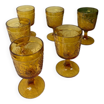 Six amber-colored stemmed glasses