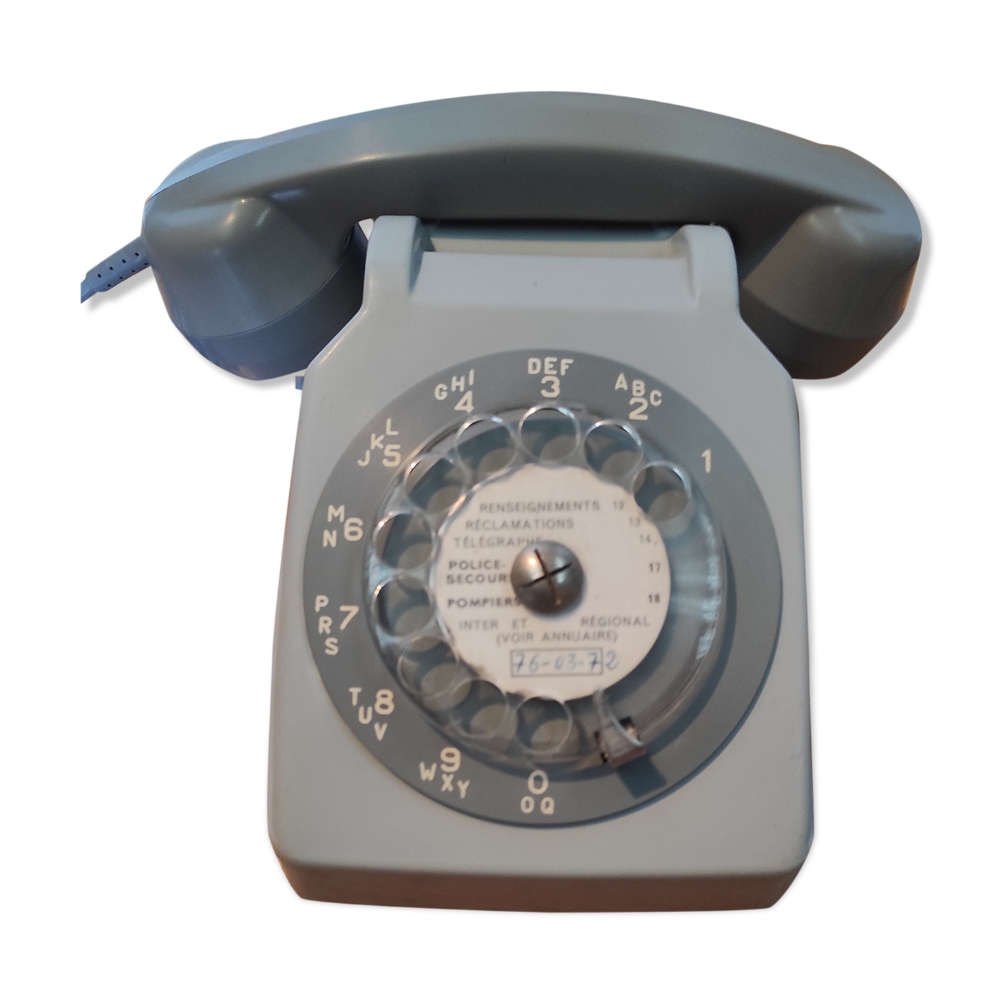 Old vintage wired dial phone with its earphone, gray color. Late 70s - early