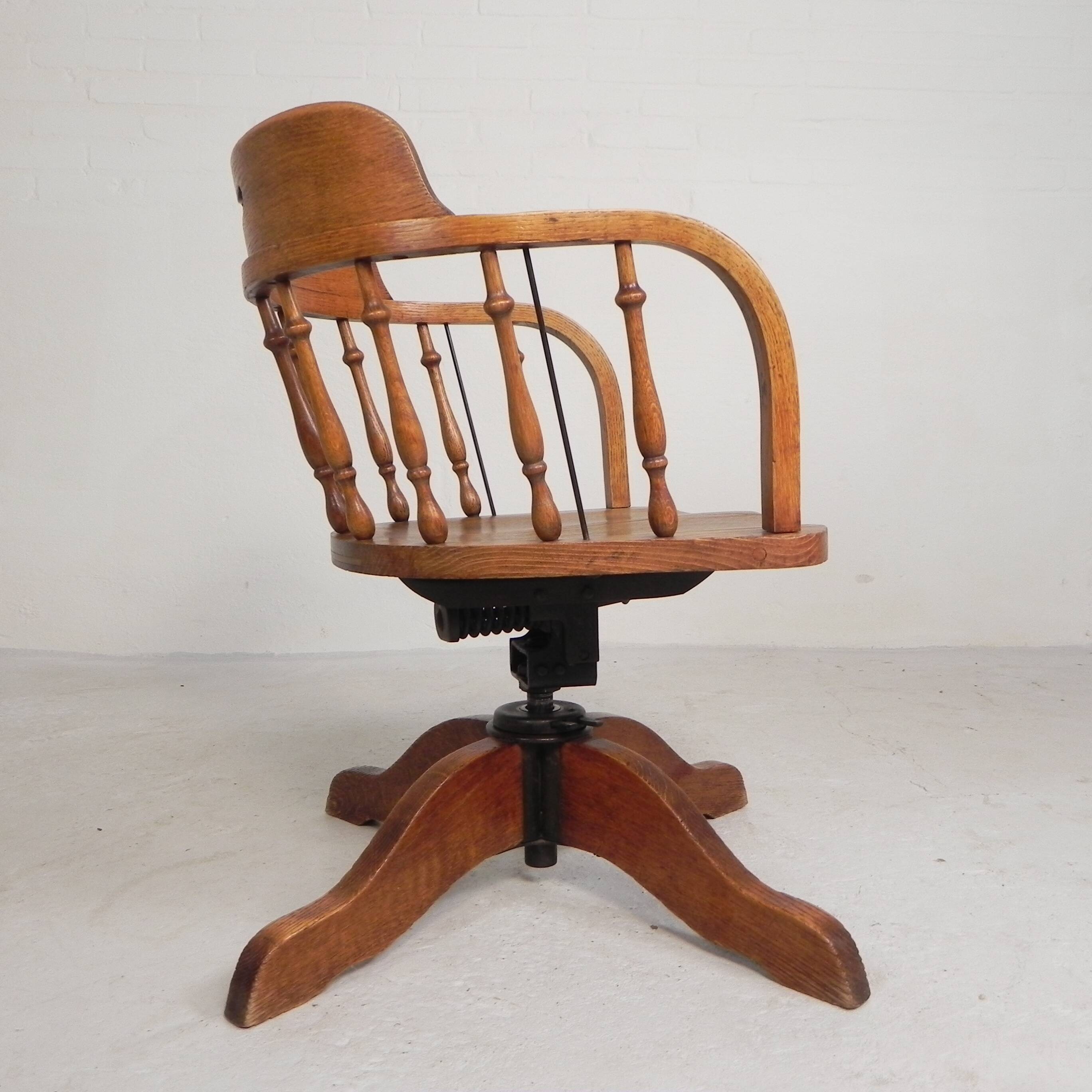 Oak office chair with a spring system and height adjustable, 1930s.