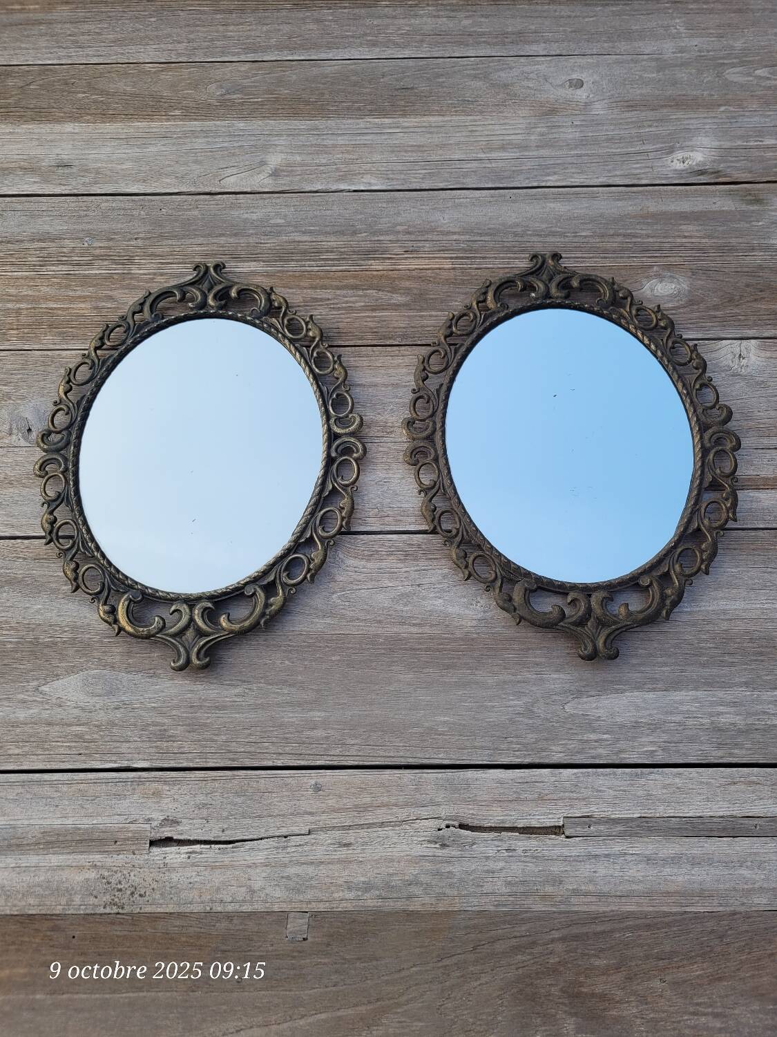 2 antique oval mirrors in heavy metal