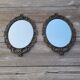 2 antique oval mirrors in heavy metal