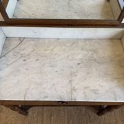 Antique bathroom cabinet with white marble and mirror.