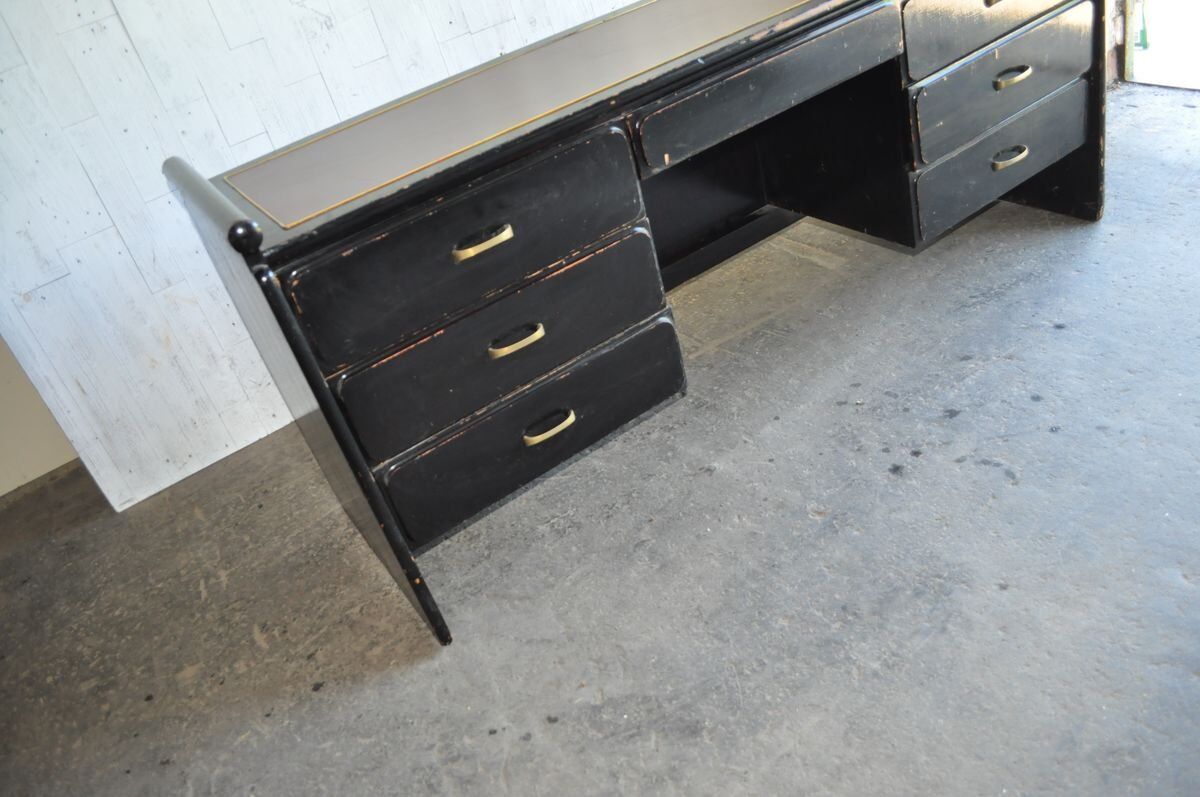 Hungarian Art Deco desk in black painted wood with a brown top and metal handles.
