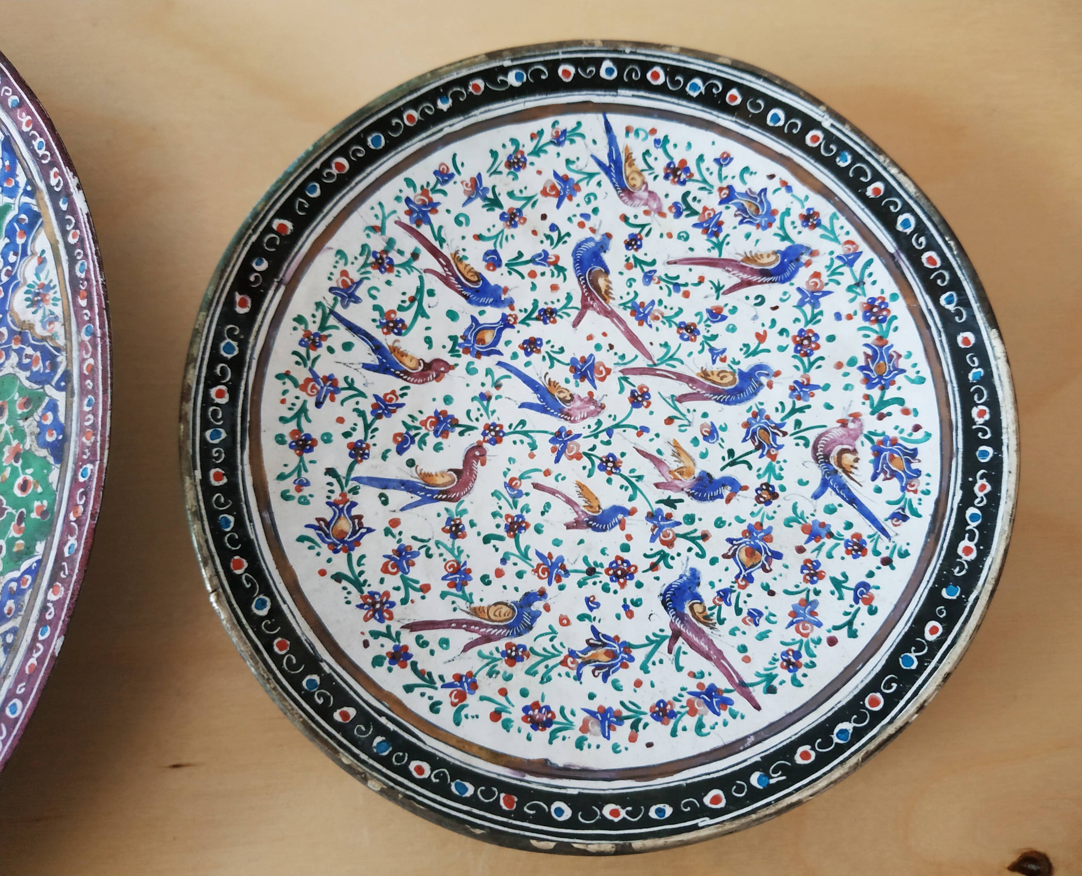 Plate and two decorative saucers enamelled with Persia decoration, circa 1940