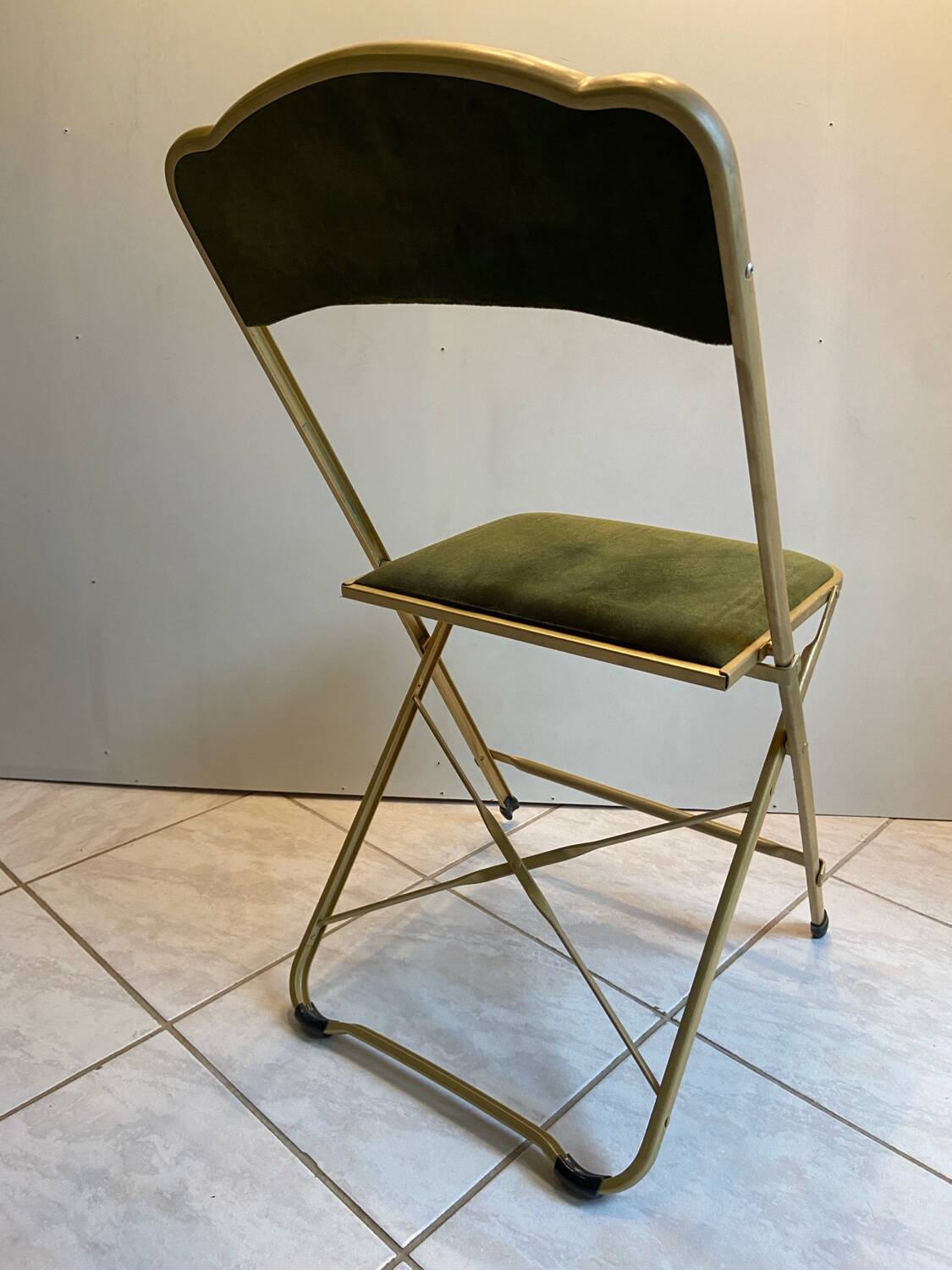 Velvet folding chair with gold metal.