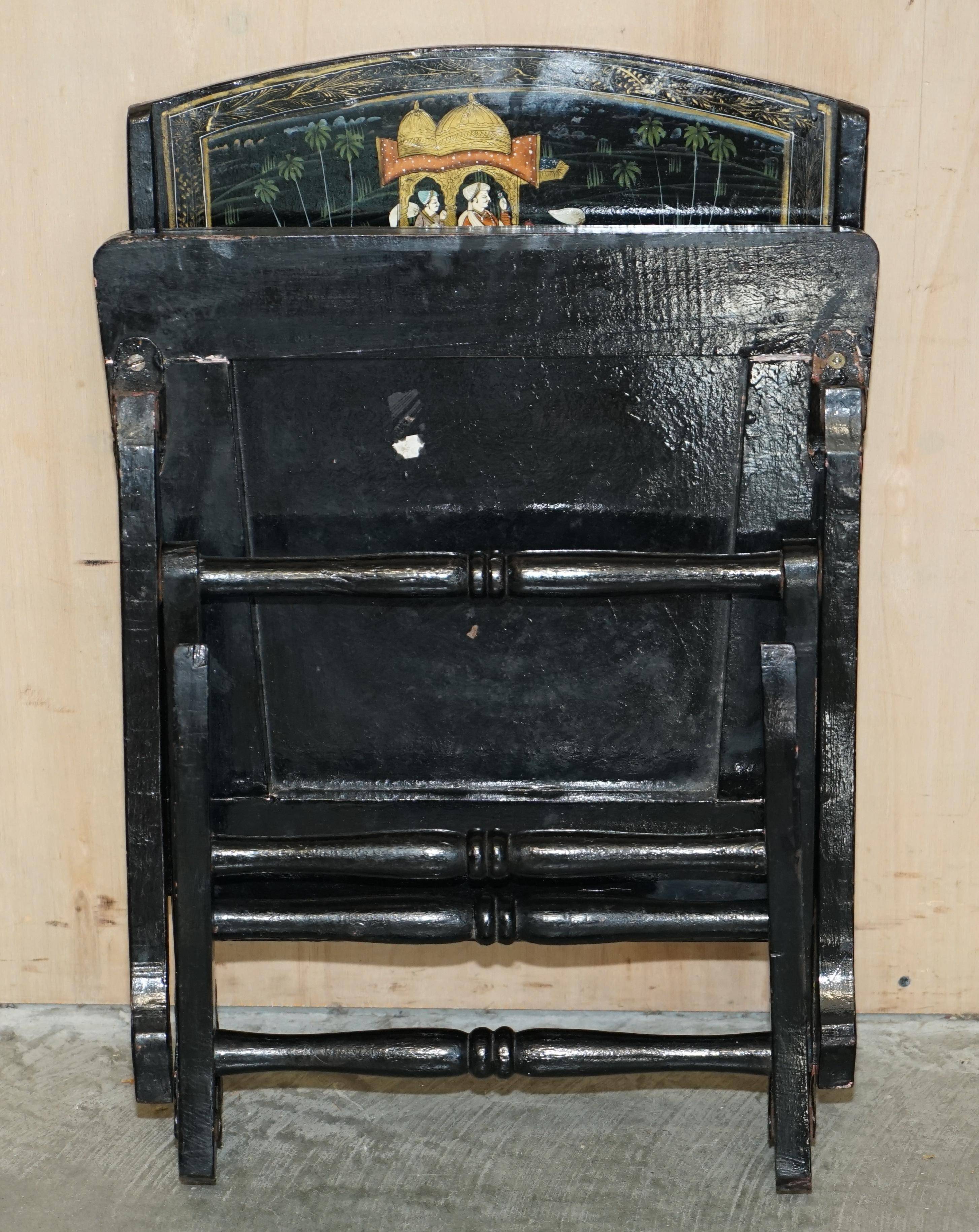 Pair of military folding chairs with Indian decoration.