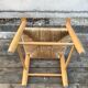 Old wooden children's armchair and vintage woven straw seat