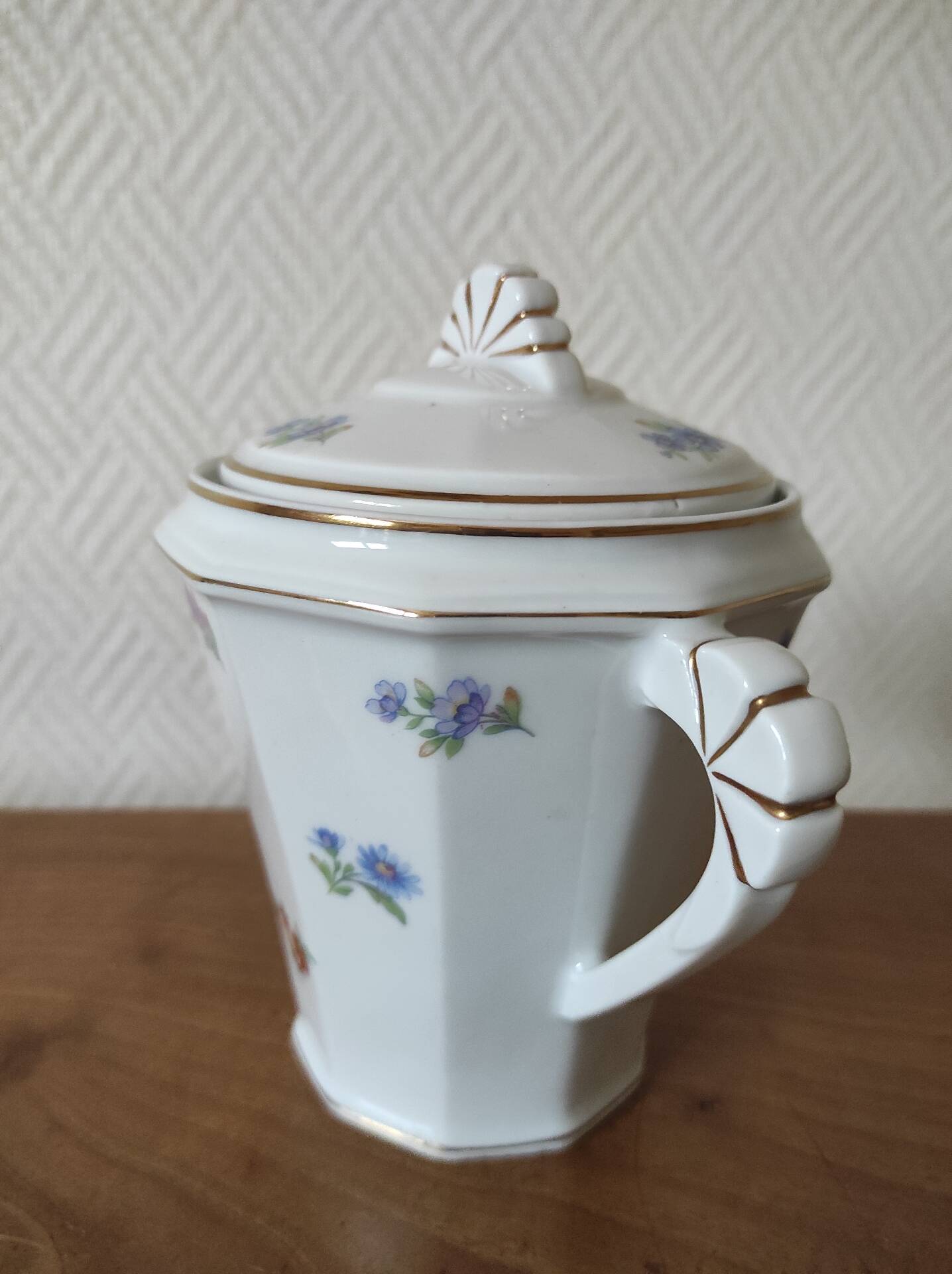 Antique porcelain sugar bowl with a decagonal base.