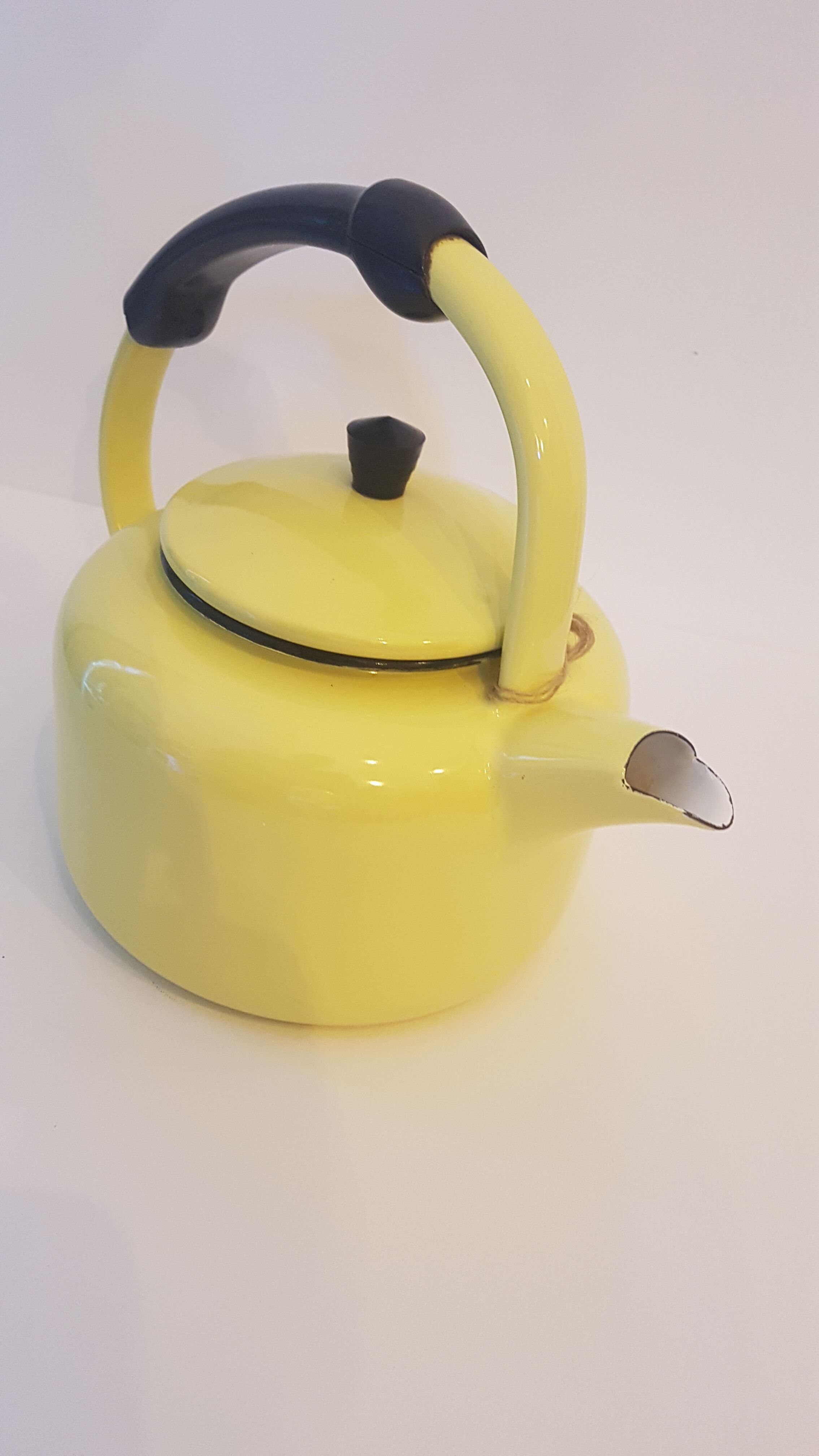Old kettle enamelled pale yellow