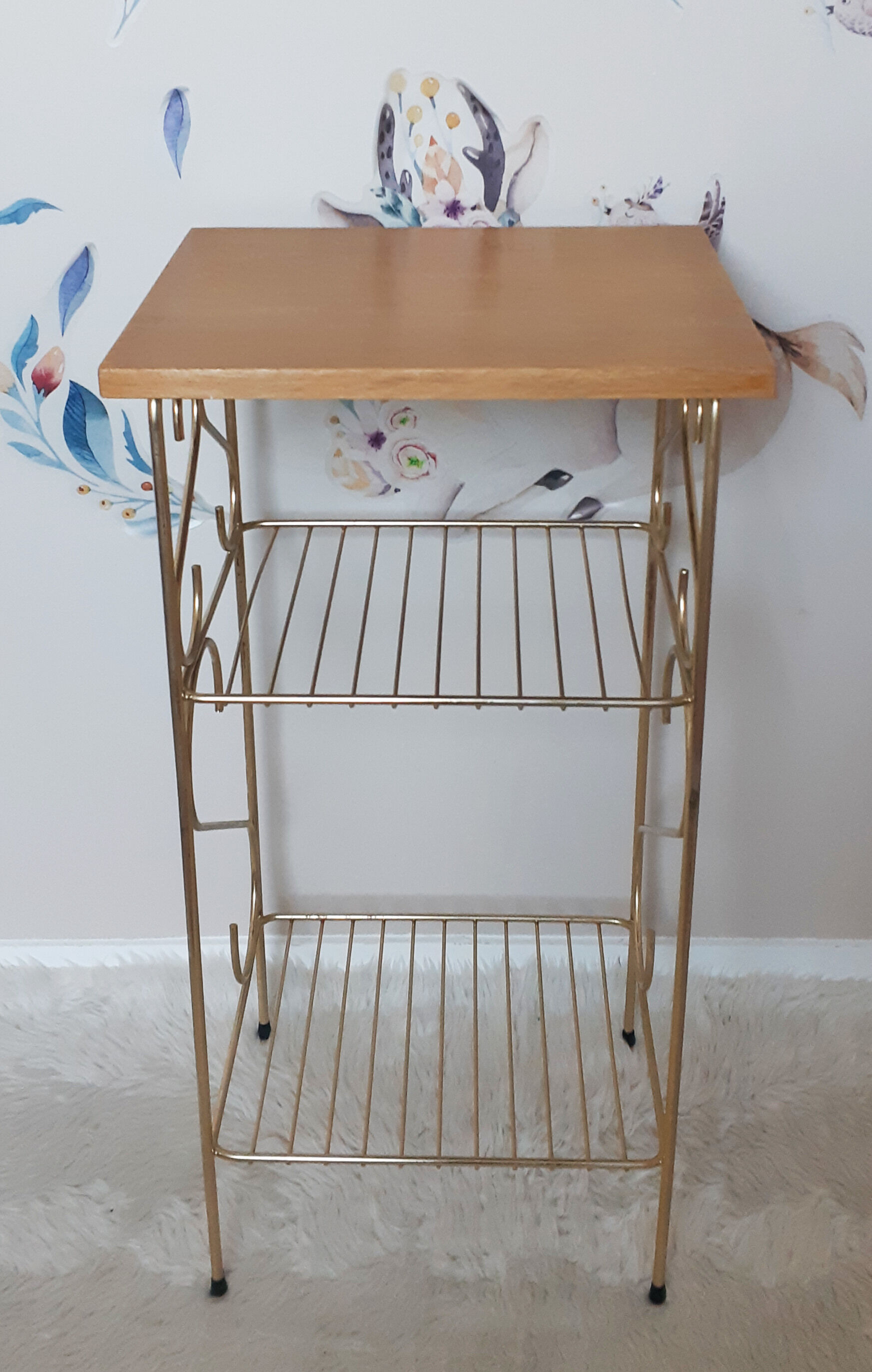 Side table with a golden magazine holder