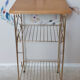 Side table with a golden magazine holder