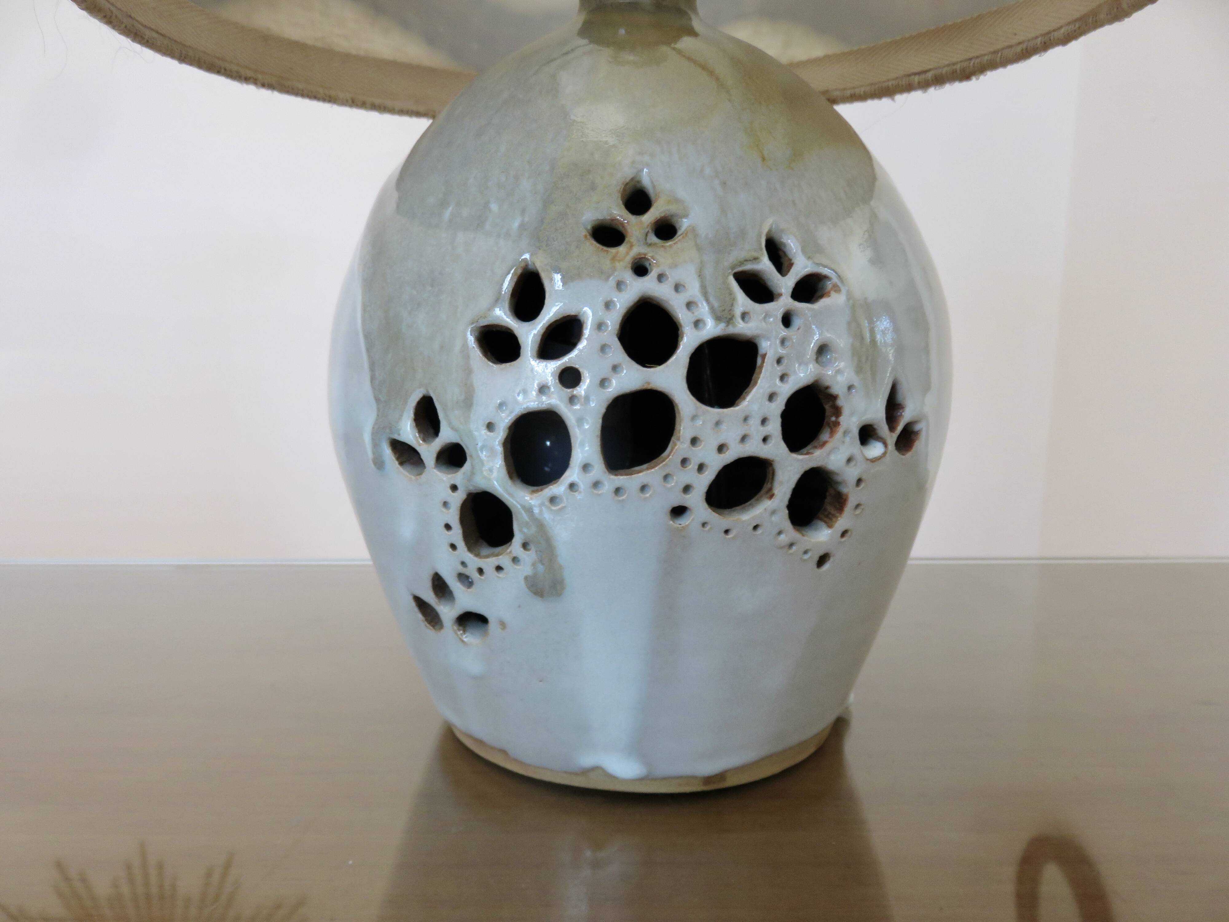 Ceramic lamp with double lighting and openwork design.