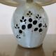 Ceramic lamp with double lighting and openwork design.