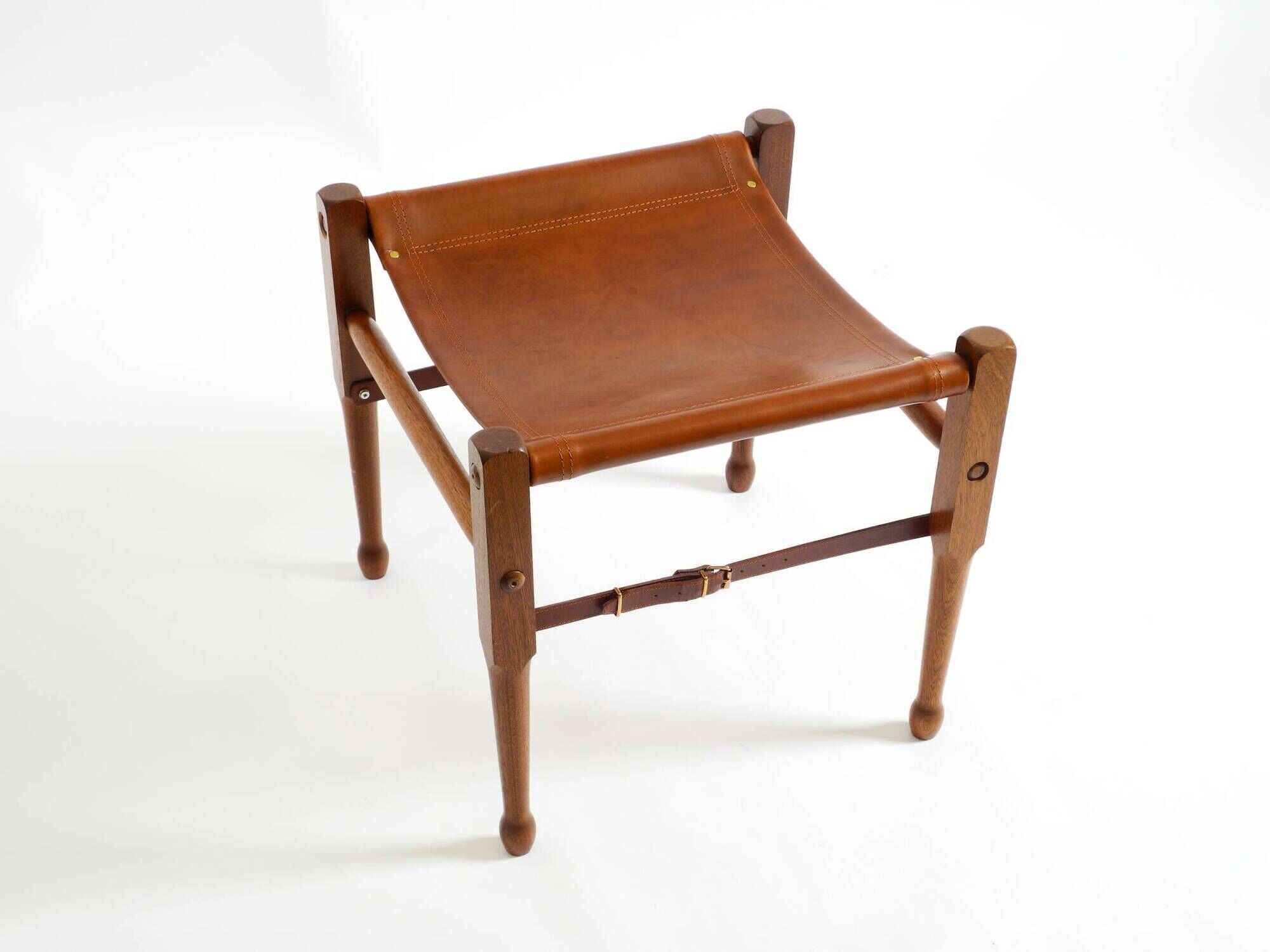 Rare 1990s safari stool with a teak frame and a seat made of brown saddle l