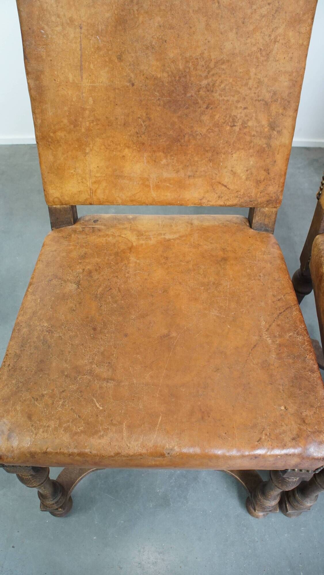 Set of 4 antique wooden and sheepskin leather dining chairs