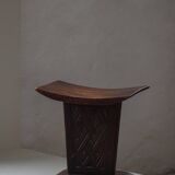 Sculptural African stool in hardwood, curved seat and architectural base, 1970s.