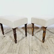 A pair of English upholstered pouffes/footstools from the 19th century