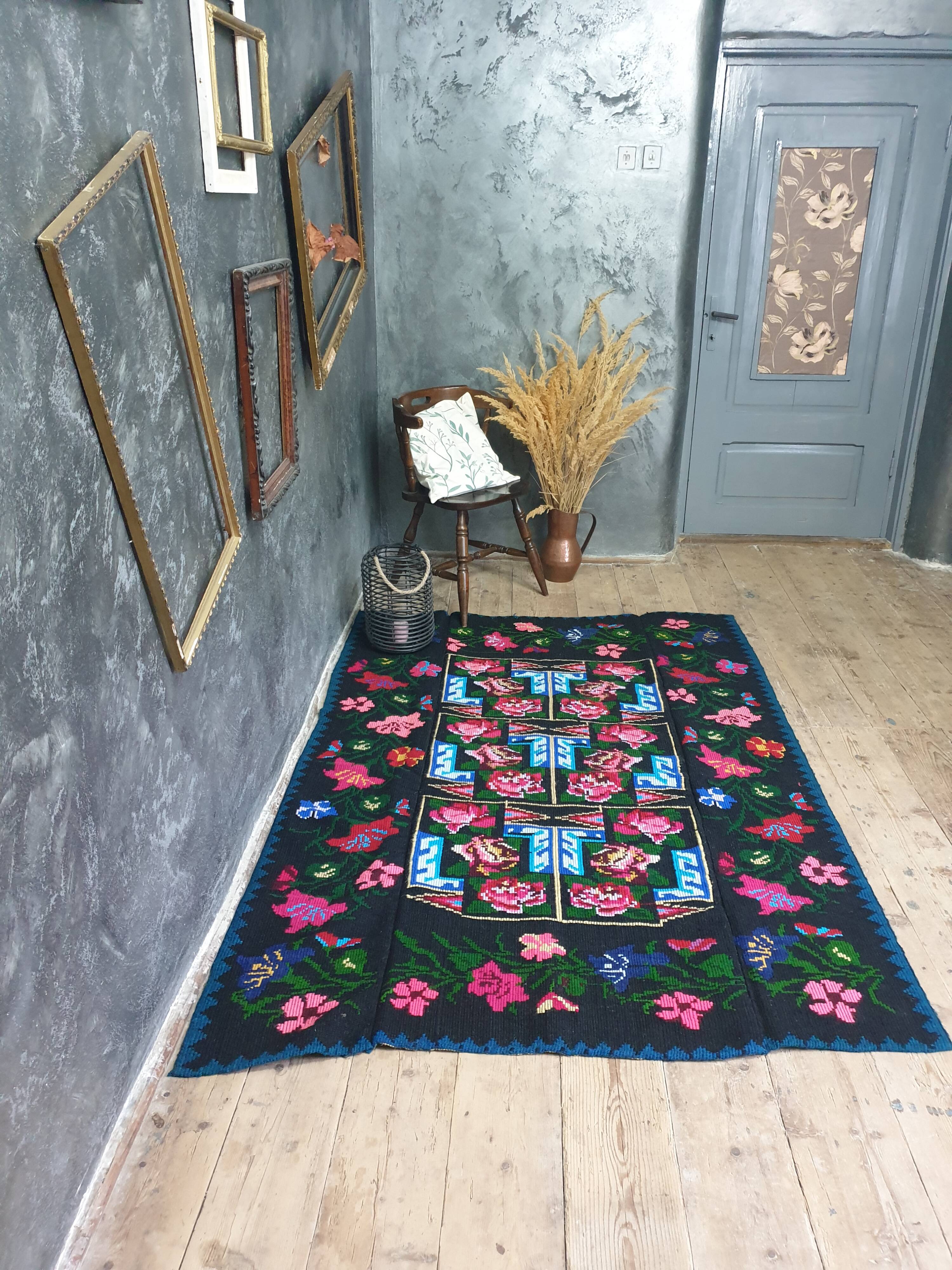 Handwoven floral wool rug, black background with pink roses and geometric design 207x144cm