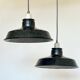 Pair of black and white industrial pendant lights with ceramic sockets