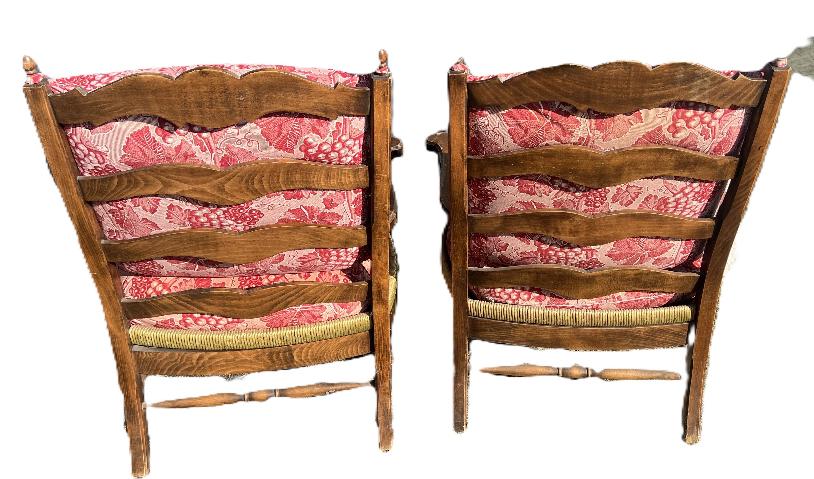 pair of rustic wood and fabric armchairs