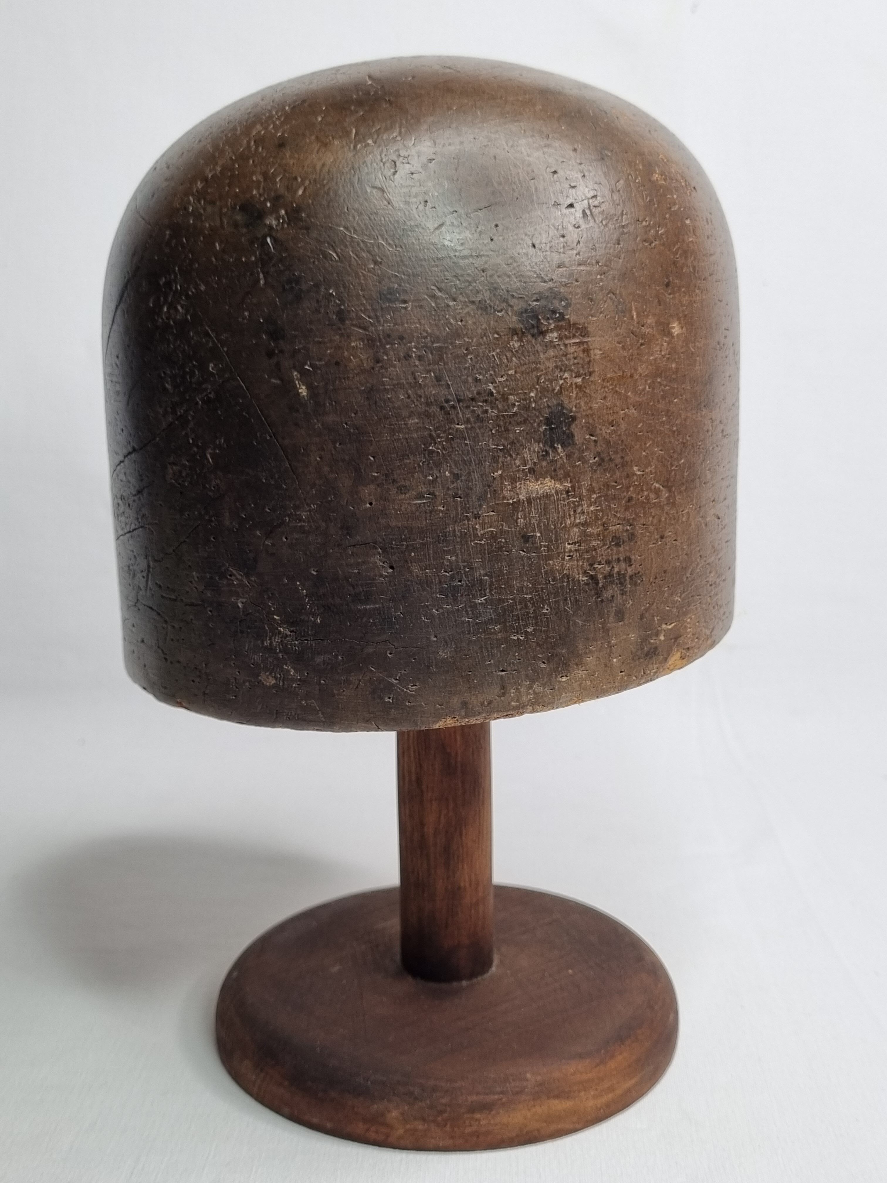 Old solid wood hat shape on foot, 1900