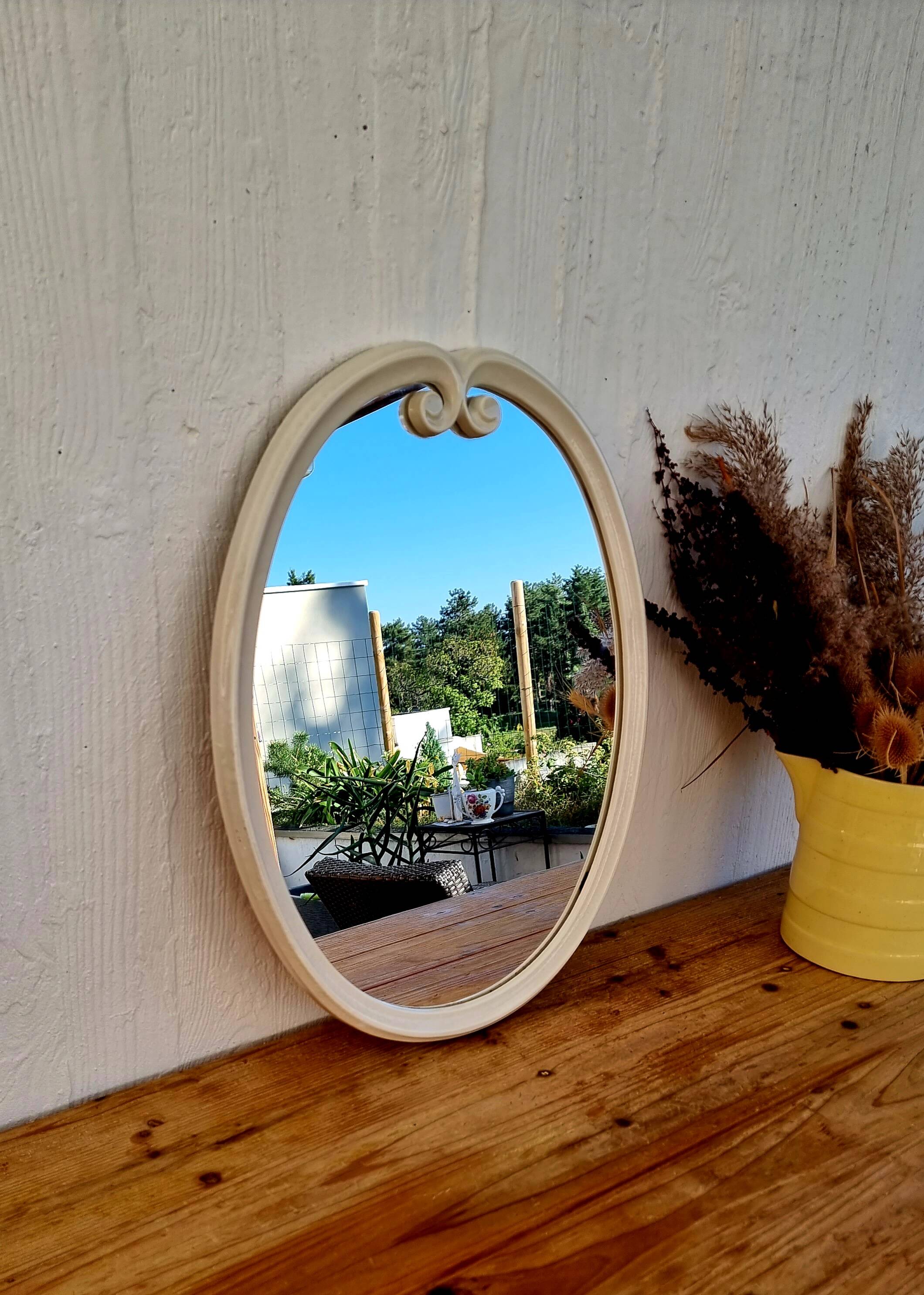 Vintage enamelled metal oval mirror