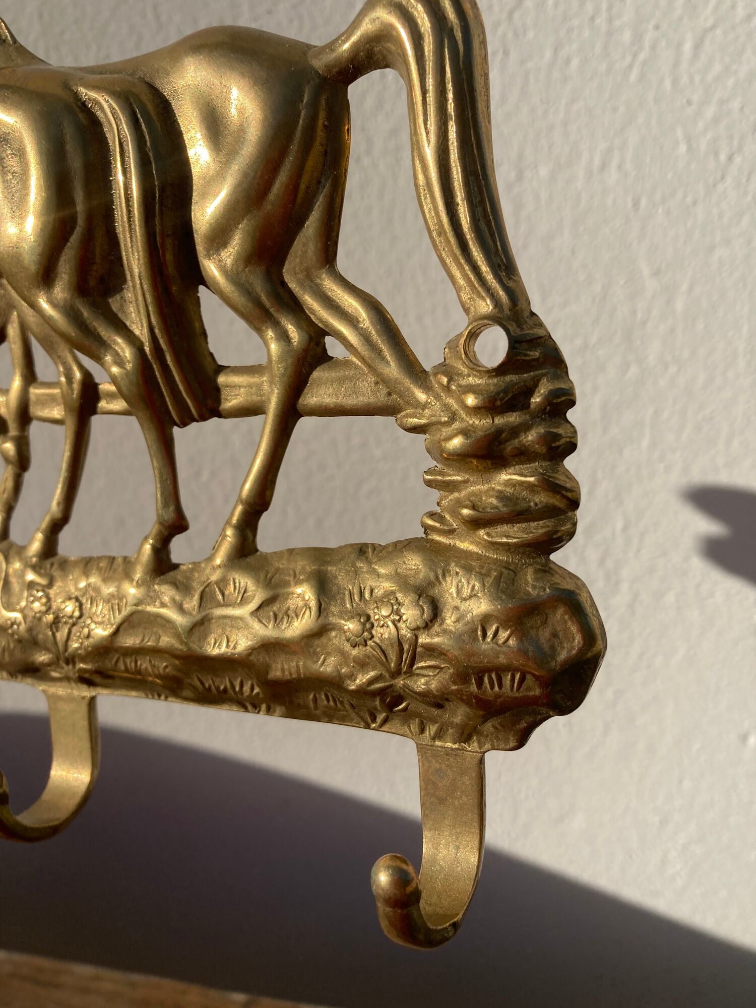Hook for keys or tea towels in gilded brass with carved horse decoration