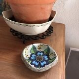 Cup lava foam with blue flower.