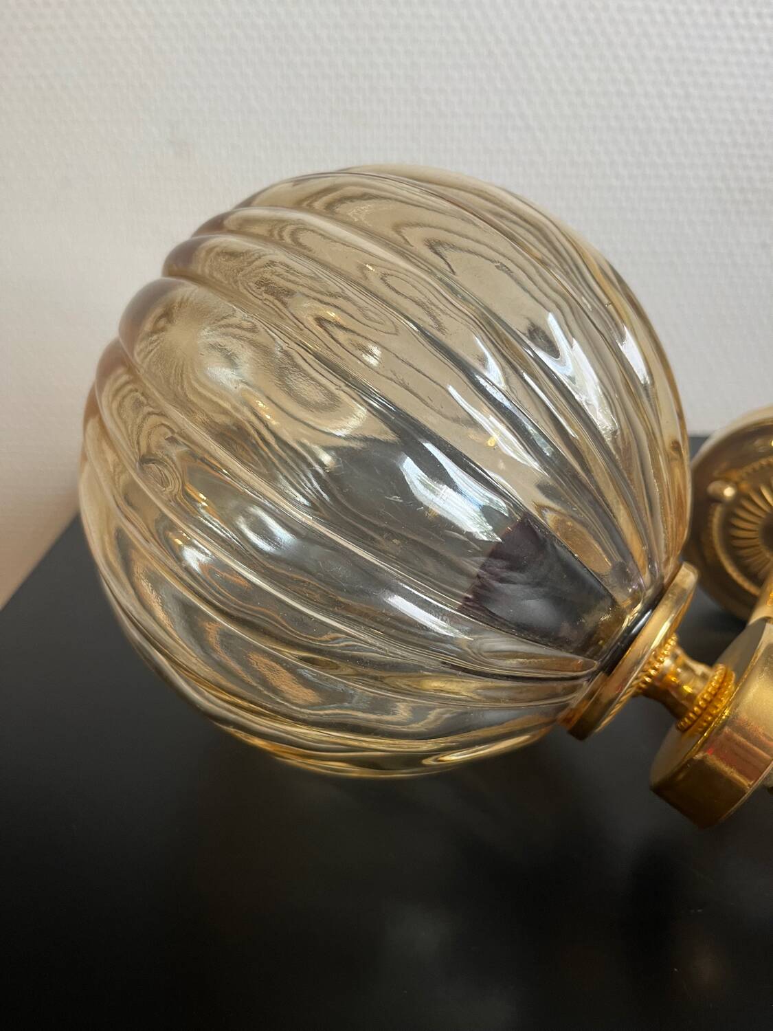 Brass wall light and bubbled glass globe