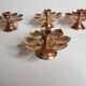 Set of four copper candlesticks in the shape of lotus flowers