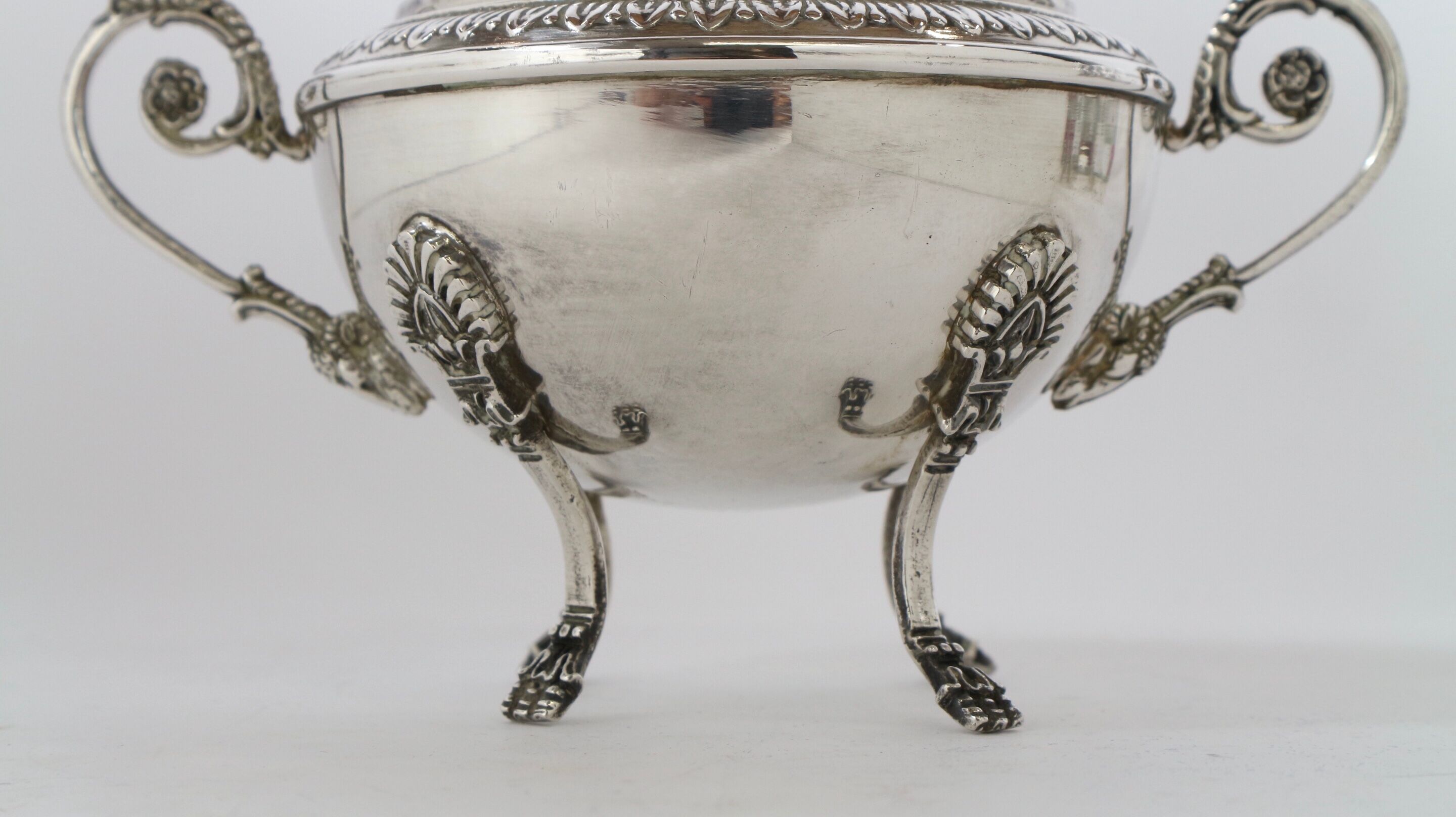 Silver sugar bowl with paw feet and ornate handles