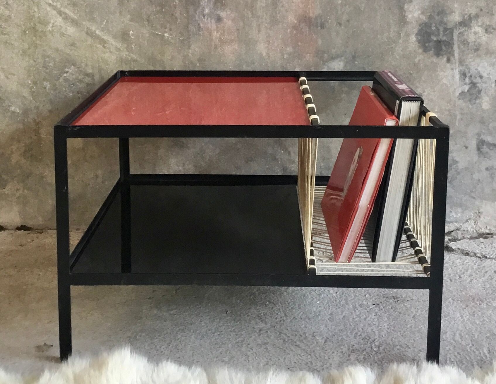 Modernist metal coffee table with a magazine rack in 1950s design.