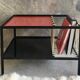 Modernist metal coffee table with a magazine rack in 1950s design.