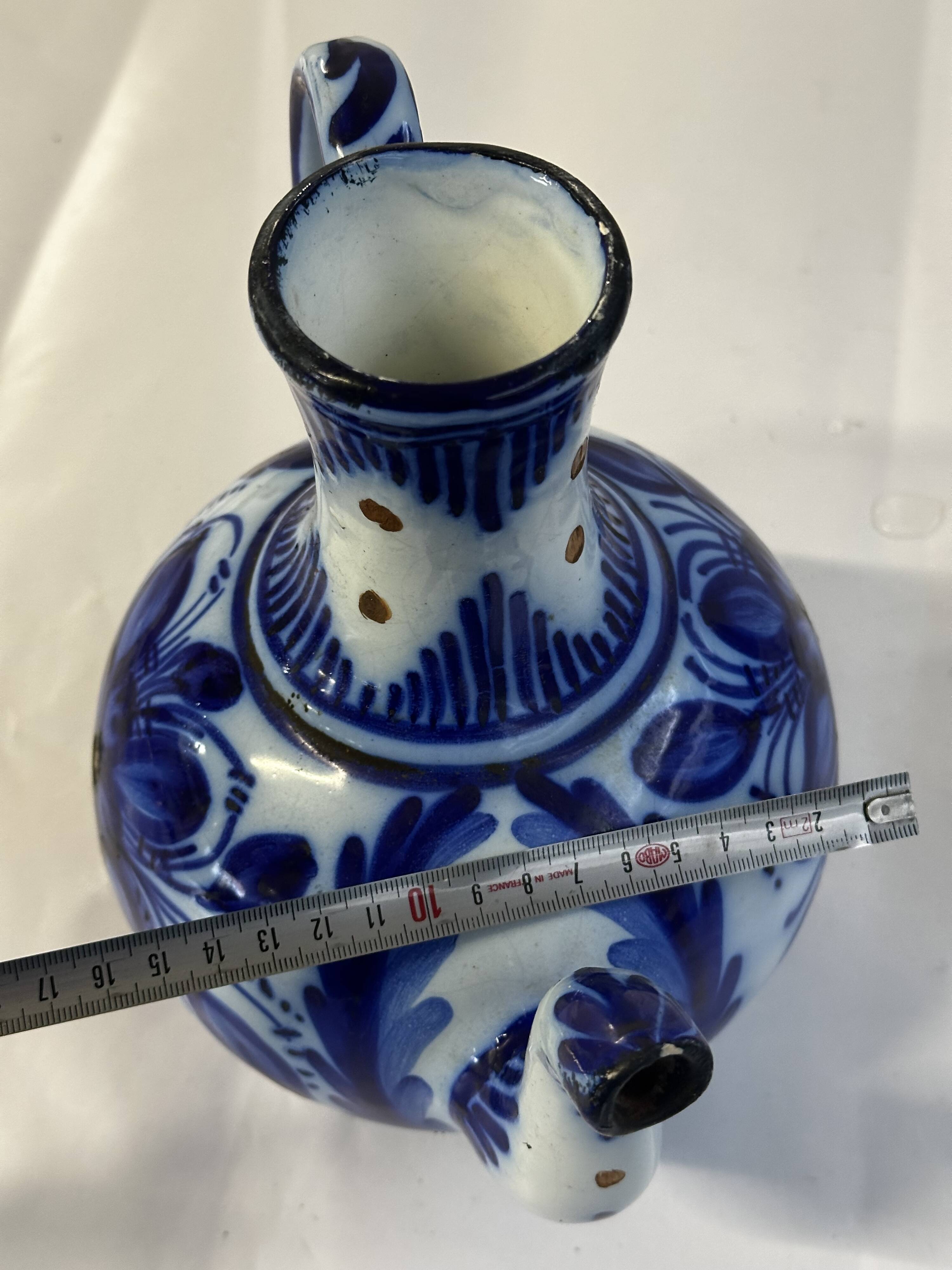 Glazed ceramic carafe with floral decoration
