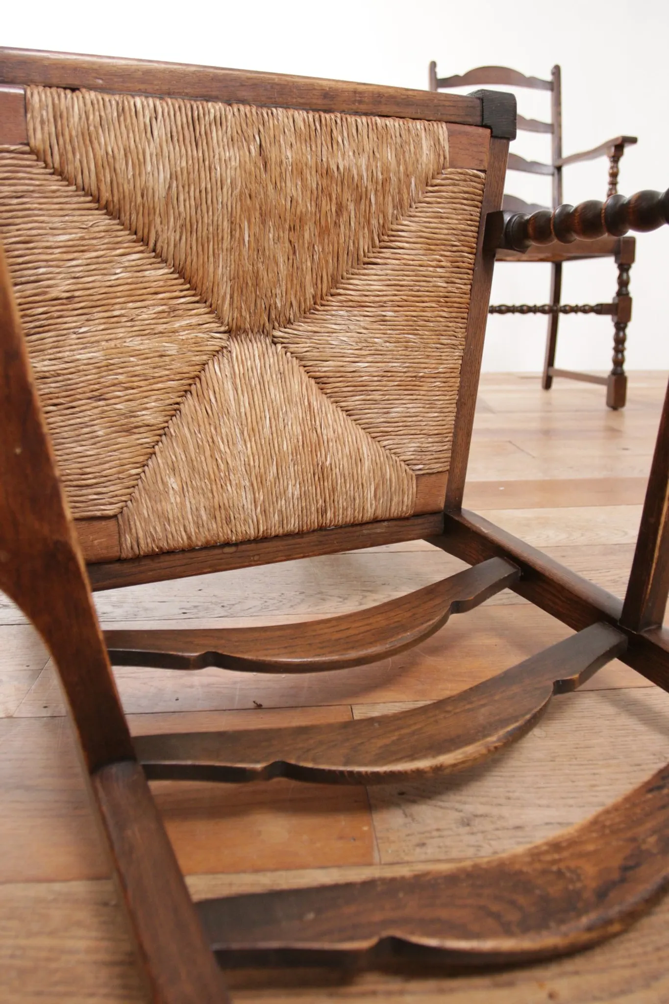 Pair of English oak armchairs with ladder back and rush seats