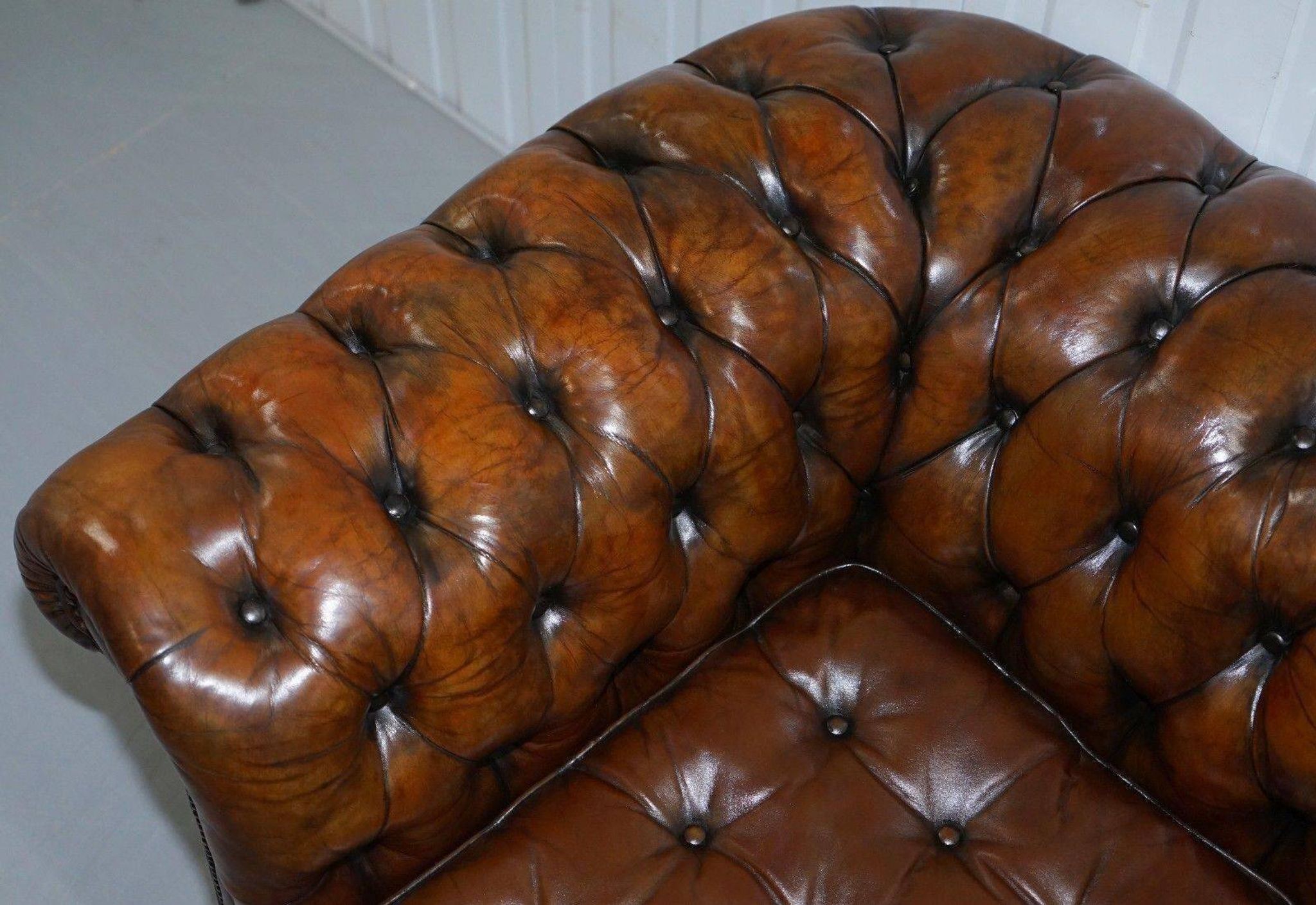 Restored vintage leather Chesterfield canapé in Thomas Chippendale style.