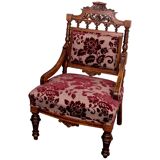 Antique lacquered wooden armchair with burgundy fabric, carved, before 1890.