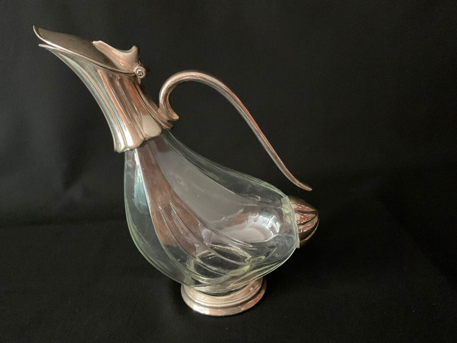 Glass decanter and silver metal duck