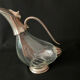 Glass decanter and silver metal duck