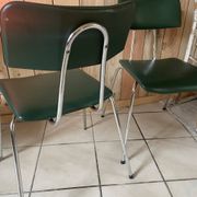 Pair of green faux leather chairs