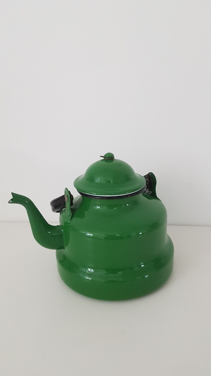 Old green kettle in enamelled metal