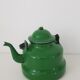 Old green kettle in enamelled metal