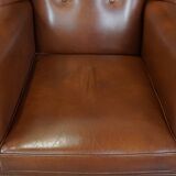 Cognac-colored leather wingback chair in English style