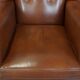 Cognac-colored leather wingback chair in English style