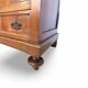 Antique walnut commode with bronze handles in the shape of a lion's mask,