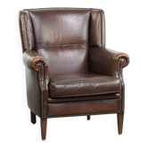 Subtle sheepskin wingback armchair with a deep cognac colour